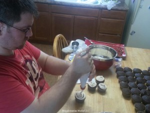 Alex busy frosting his Man Cakes.