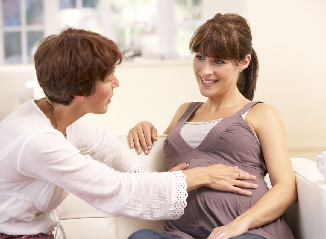 Pregnant woman talking to midwife